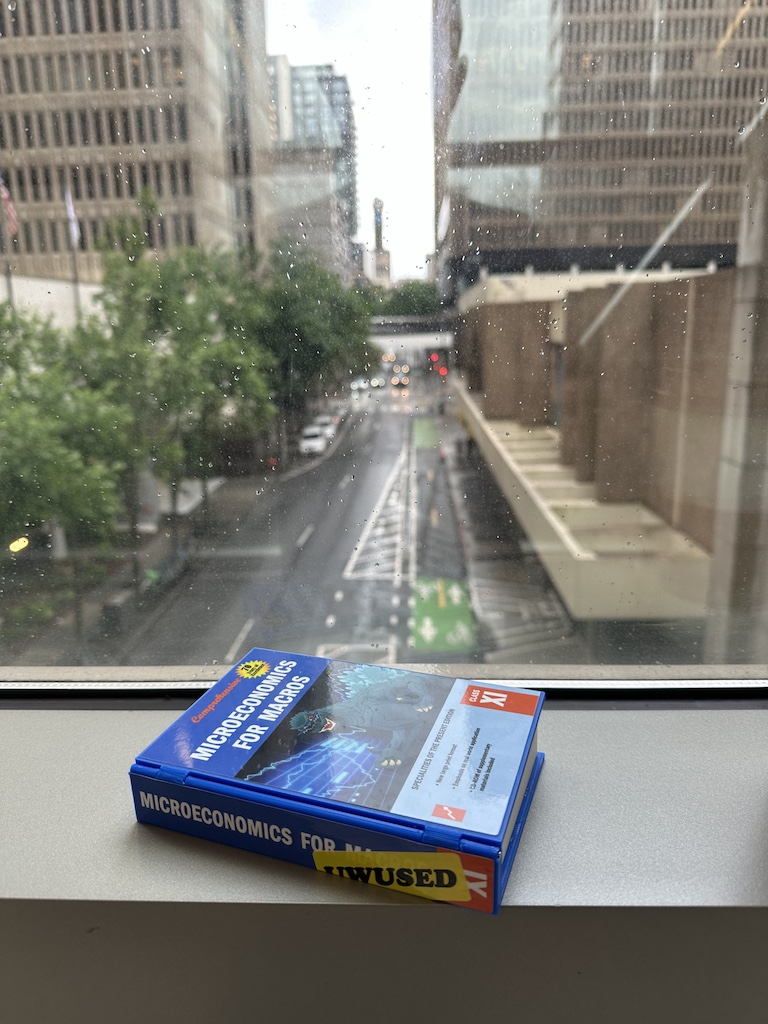 photograph of a book sitting on a window sill