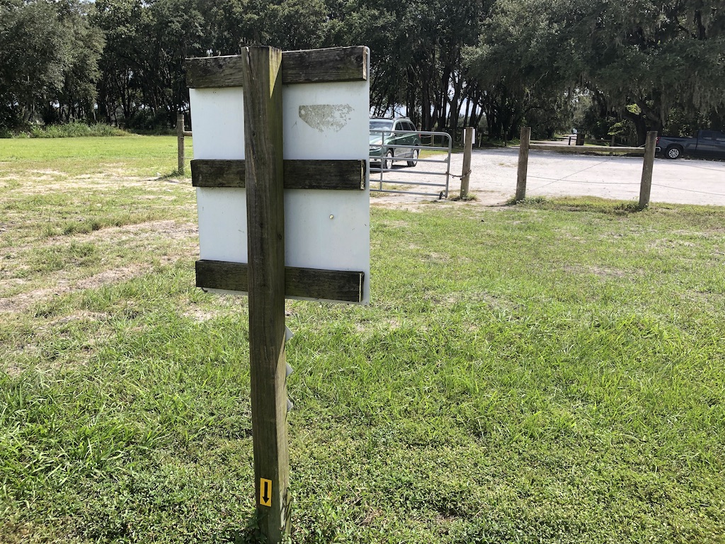 the mailbox along a road with a sticker on one of the poles